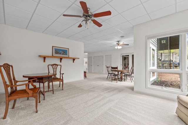 interior space featuring baseboards, a paneled ceiling, and ceiling fan