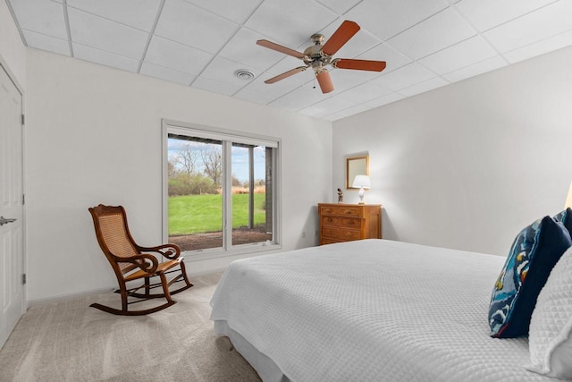 carpeted bedroom featuring baseboards, ceiling fan, a paneled ceiling, and visible vents