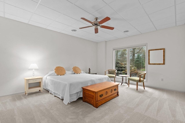 carpeted bedroom with baseboards, visible vents, a ceiling fan, and a paneled ceiling