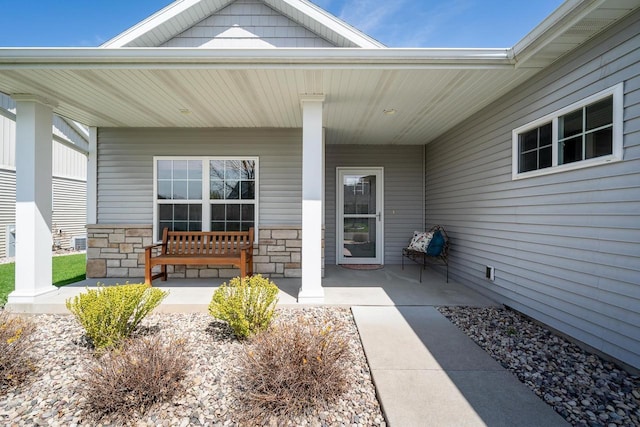 exterior space featuring a porch and stone siding