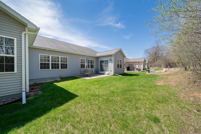 back of house featuring a lawn and a patio