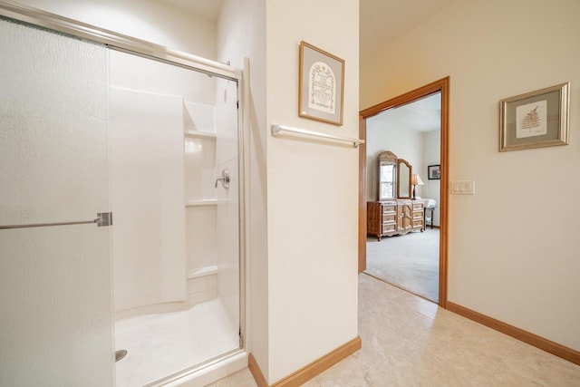 bathroom featuring tile patterned flooring, baseboards, and a stall shower