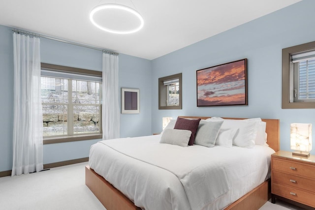 6667 S Chickahauk Trl, Middleton, WI 53562 - bedroom with multiple windows, light colored carpet, and baseboards