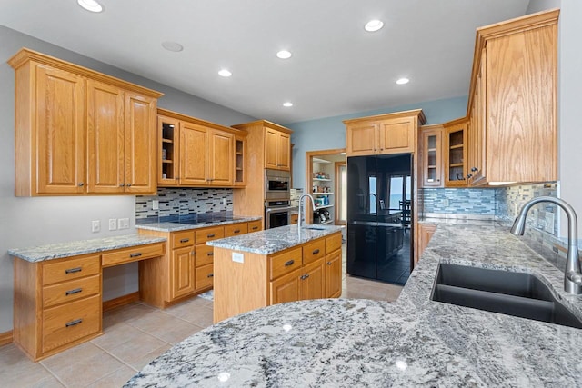 kitchen with recessed lighting, a sink, backsplash, and black appliances