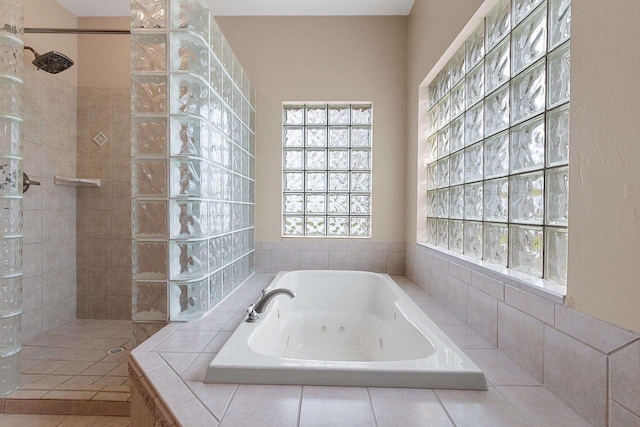 bathroom with a walk in shower and a tub with jets
