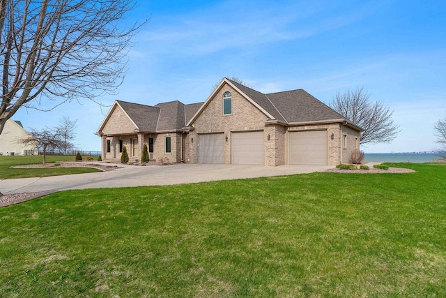 view of front facade with brick siding, an attached garage, driveway, and a front yard