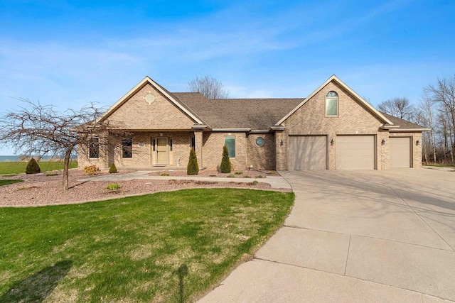 ranch-style home featuring an attached garage, driveway, a front lawn, and brick siding