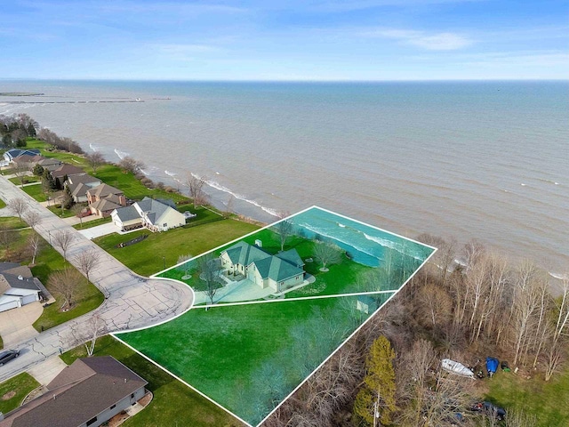 drone / aerial view with a water view and a residential view