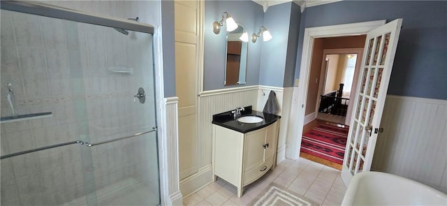 422 W Columbia St, Chippewa Falls, WI 54729 - bathroom with a decorative wall, vanity, tile patterned floors, a wainscoted wall, and a stall shower