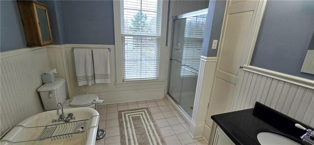 422 W Columbia St, Chippewa Falls, WI 54729 - full bath featuring tile patterned flooring, wainscoting, a freestanding tub, a decorative wall, and a shower stall