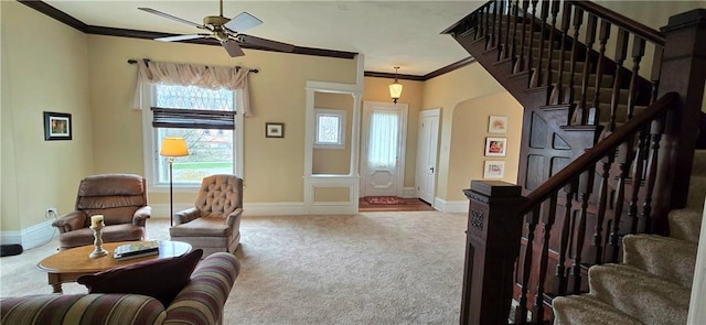 422 W Columbia St, Chippewa Falls, WI 54729 - carpeted living area featuring crown molding, arched walkways, a ceiling fan, and stairway