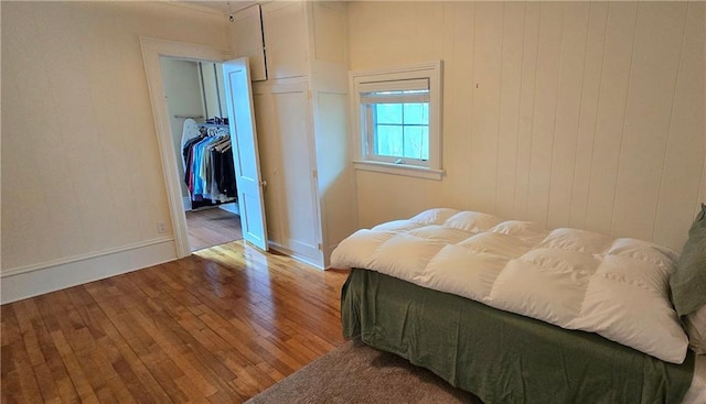 422 W Columbia St, Chippewa Falls, WI 54729 - bedroom featuring wood-type flooring, baseboards, a walk in closet, and a closet