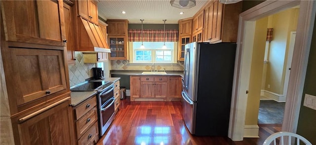 422 W Columbia St, Chippewa Falls, WI 54729 - kitchen featuring dark wood-style flooring, a sink, brown cabinetry, stainless steel appliances, and backsplash