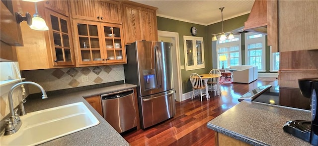 422 W Columbia St, Chippewa Falls, WI 54729 - kitchen featuring decorative backsplash, dark wood-style flooring, a sink, hanging light fixtures, and stainless steel appliances