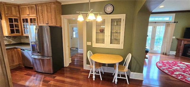 422 W Columbia St, Chippewa Falls, WI 54729 - kitchen featuring decorative backsplash, dark wood-style flooring, glass insert cabinets, brown cabinets, and stainless steel appliances