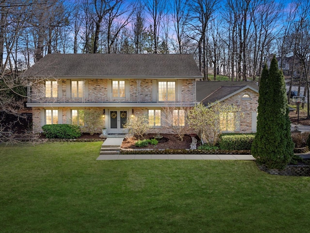 19425 Killarney Way, Brookfield, WI 53045 - traditional home with a lawn, a shingled roof, french doors, and brick siding