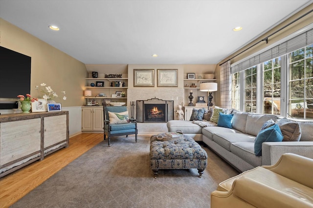 19425 Killarney Way, Brookfield, WI 53045 - living area featuring recessed lighting, a lit fireplace, built in shelves, and light wood-style floors