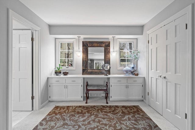 19425 Killarney Way, Brookfield, WI 53045 - bar featuring a healthy amount of sunlight, baseboards, hanging light fixtures, and built in desk