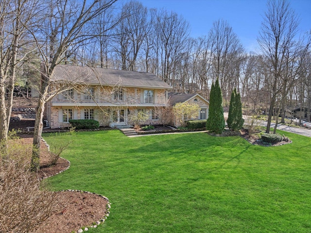 19425 Killarney Way, Brookfield, WI 53045 - traditional-style house with french doors, a front yard, and stone siding