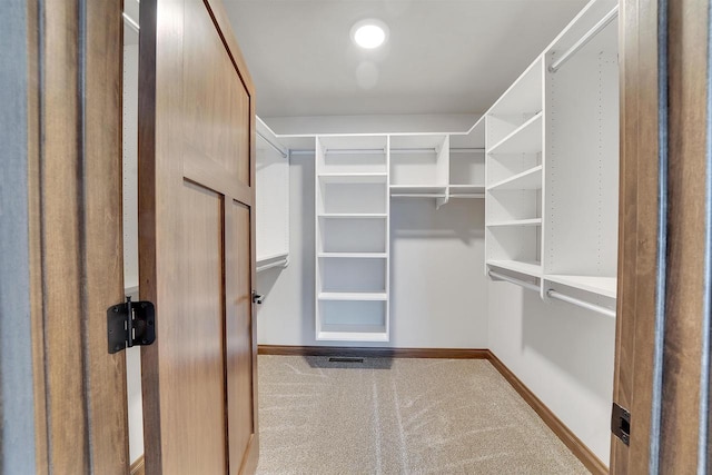 spacious closet with carpet flooring
