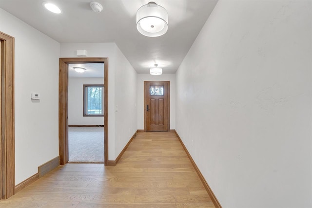 interior space featuring baseboards and light wood-type flooring