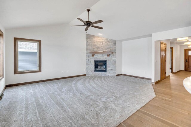 unfurnished living room featuring ceiling fan, vaulted ceiling, baseboards, and light wood finished floors