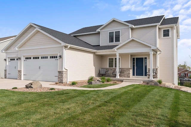 view of front facade with covered porch, an attached garage, stone siding, driveway, and a front lawn