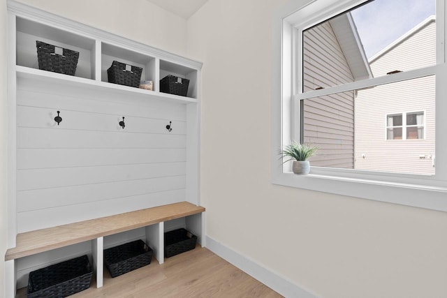 mudroom featuring wood finished floors and baseboards