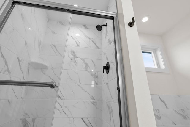 bathroom with a shower stall and recessed lighting
