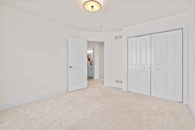 unfurnished bedroom with carpet flooring, baseboards, and a closet