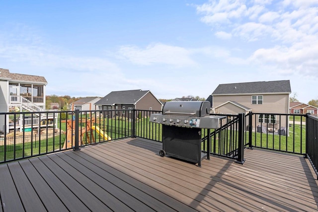 wooden terrace featuring a grill and a residential view