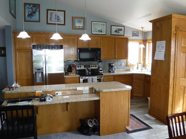 10621 Cth F, Newton, WI 53063 - kitchen featuring brown cabinets, appliances with stainless steel finishes, vaulted ceiling, and light wood-style floors