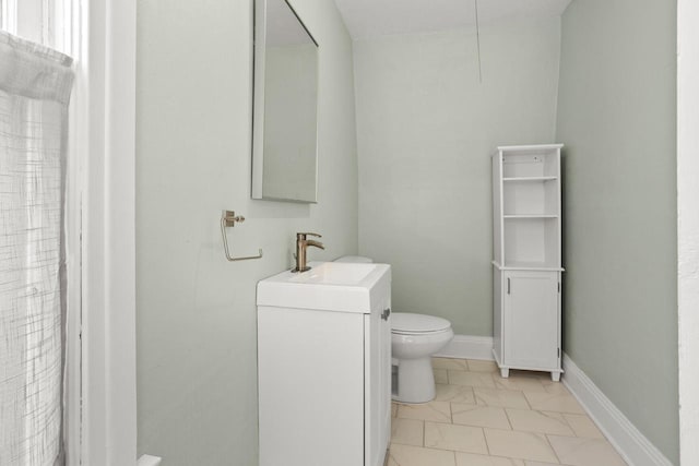 full bath with vanity, marble finish floor, and toilet