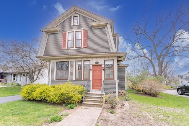 dutch colonial featuring a front lawn