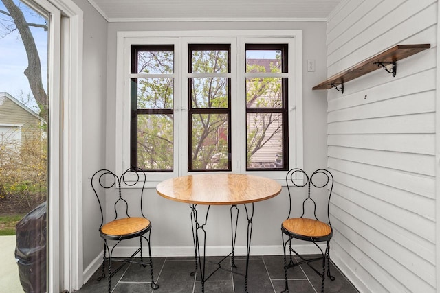 dining room with baseboards and crown molding