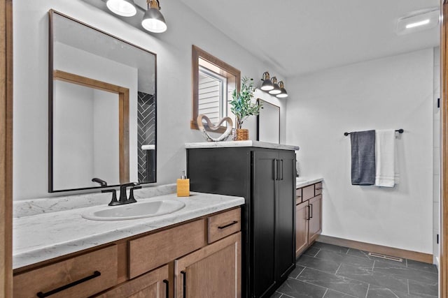 full bathroom featuring a sink, baseboards, visible vents, and two vanities
