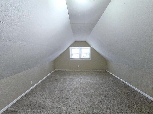 5870 N 72nd St, Milwaukee, WI 53218 - additional living space with carpet floors, baseboards, and vaulted ceiling