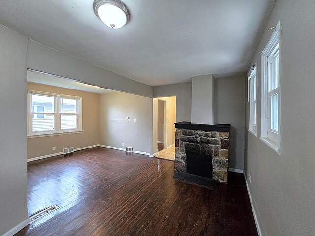 5870 N 72nd St, Milwaukee, WI 53218 - unfurnished living room featuring a fireplace, baseboards, visible vents, and hardwood / wood-style floors