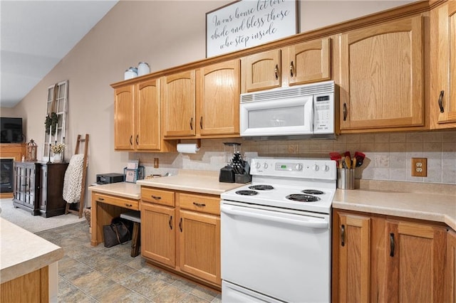 kitchen with light countertops, lofted ceiling, white appliances, and tasteful backsplash