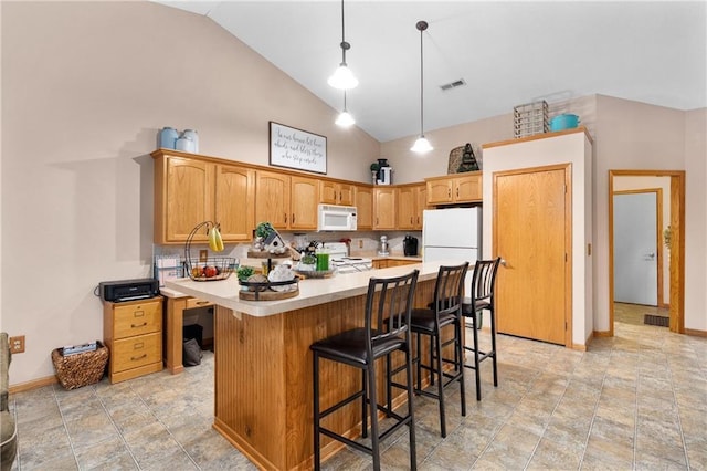 kitchen with a breakfast bar, white appliances, light countertops, high vaulted ceiling, and visible vents