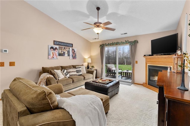 carpeted living area featuring vaulted ceiling, baseboards, a ceiling fan, and visible vents