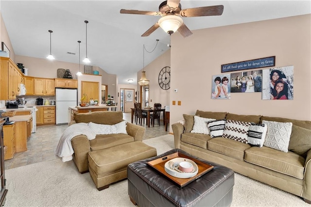 living room featuring visible vents, a ceiling fan, and high vaulted ceiling