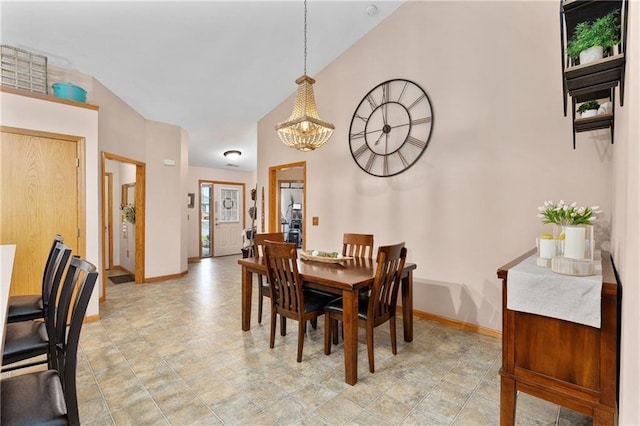 dining area with baseboards and a chandelier