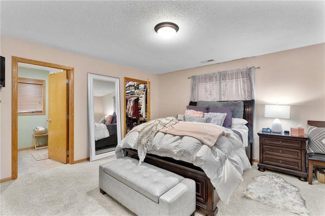 bedroom featuring baseboards, carpet, a textured ceiling, and visible vents