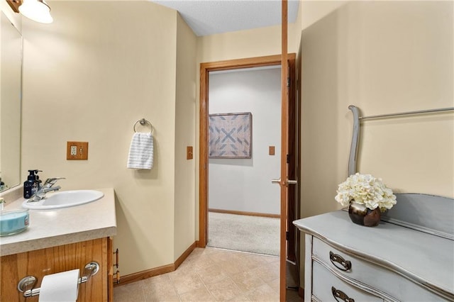 bathroom with baseboards and vanity