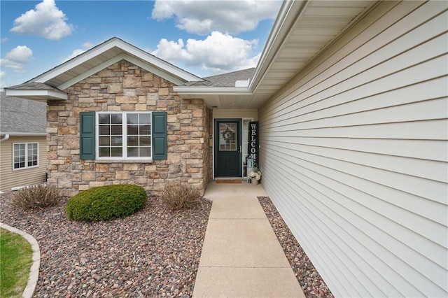 view of exterior entry featuring stone siding