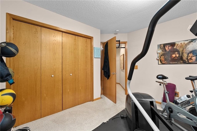 workout room with carpet floors and a textured ceiling