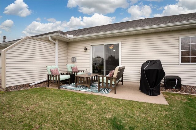 back of house featuring a yard, roof with shingles, and a patio area