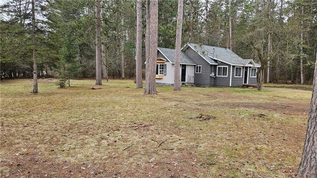 10039 State Highway 27, Hayward, WI 54843 - ranch-style home with a forest view and a front lawn