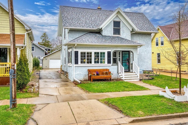 1221 S Madison St, Appleton, WI 54915 - view of front facade featuring a detached garage, an outbuilding, a shingled roof, and stucco siding